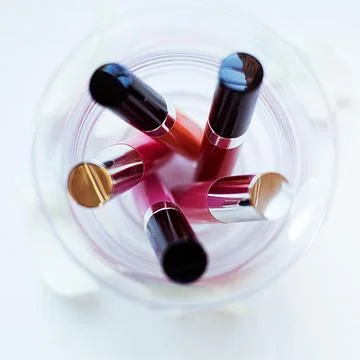 Five Assorted-color Liquid Lipsticks Placed on Glass Stock Photos