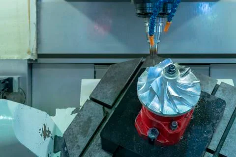 Five axis CNC machining center cutting jet engine turbine. 스톡 사진