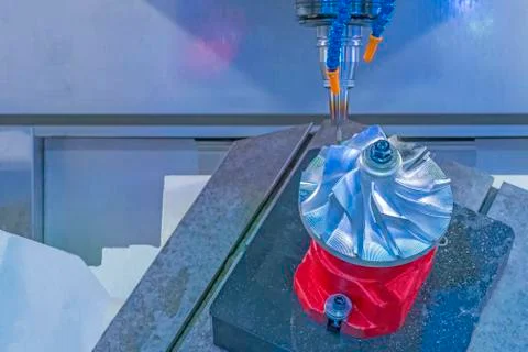 Five axis CNC machining center cutting jet engine turbine. Stock Photos