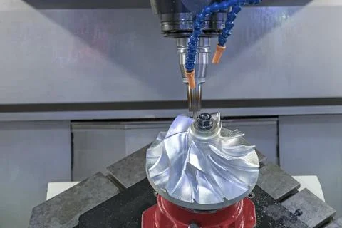 Five axis CNC machining center cutting jet engine turbine. Stock Photos
