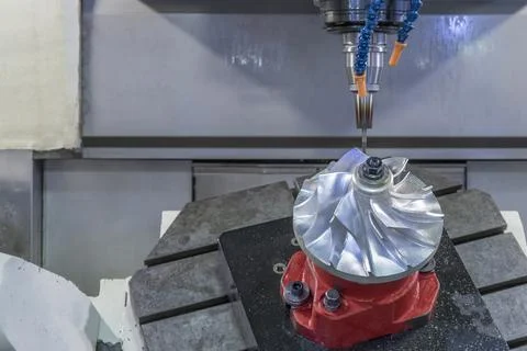 Five axis CNC machining center cutting jet engine turbine. Stock Photos