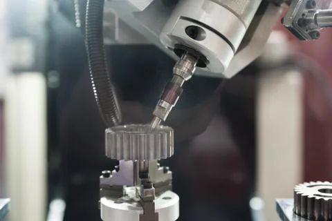 The five-axis Computer Numerical Control (CNC) machine while cutting sample g Stock Photos