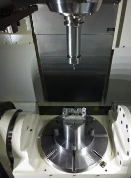 The five-axis Computer Numerical Control CNC machine waiting for stock change Stock Photos
