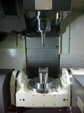 The five-axis Computer Numerical Control CNC machine waiting for stock change Stock Photos