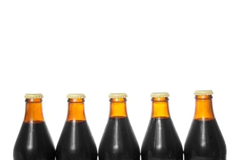 Five beer bottles isolated on a pure white background with blank copyspace ab Stock Photos