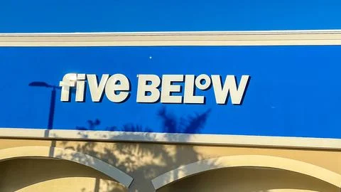 Five Below store sign displayed prominently against a clear blue sky, showcasing Stock Photos