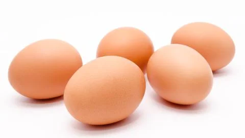 Five brown chicken eggs isolated on a white background Stock Photos