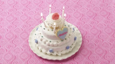 Five burning candles on a white cake Stock Footage 8571405