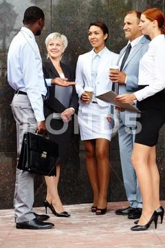 Five business people meeting outdoors and communicating Stock Photos