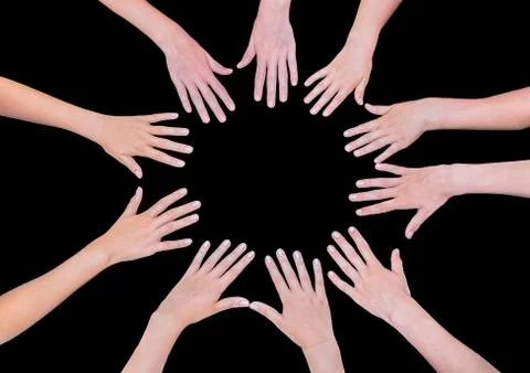 Five children hands joining in circle above black background Stock Photos