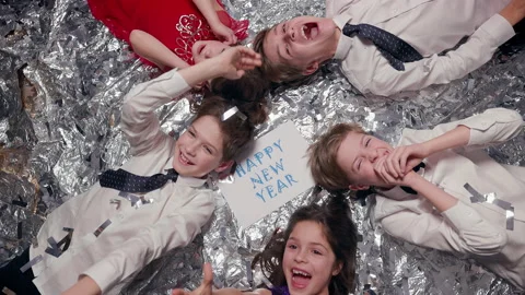 Five Children Lie On Shiny Surface. Celebration. They Are Having Fun. Stock Footage 180139446