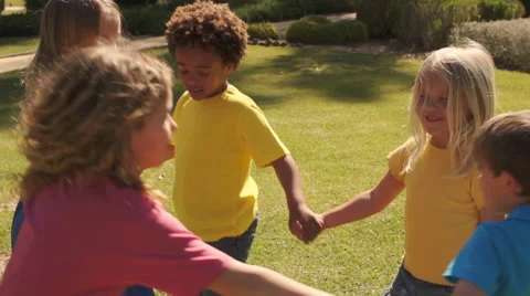 Five children paying ring-a-roses in park. Stock Footage 43673135