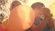 Five Children Playing In Park With Balloons. Stock Footage