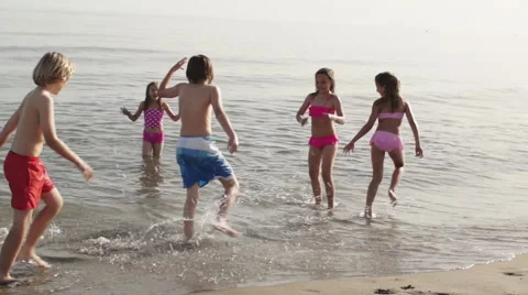 Five children playing in surf. Stock Footage 43672983