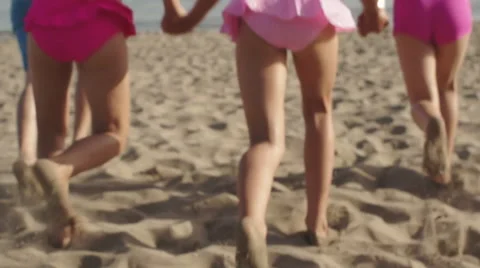 Five children running away from camera down beach to the sea. Stock Footage 43672949