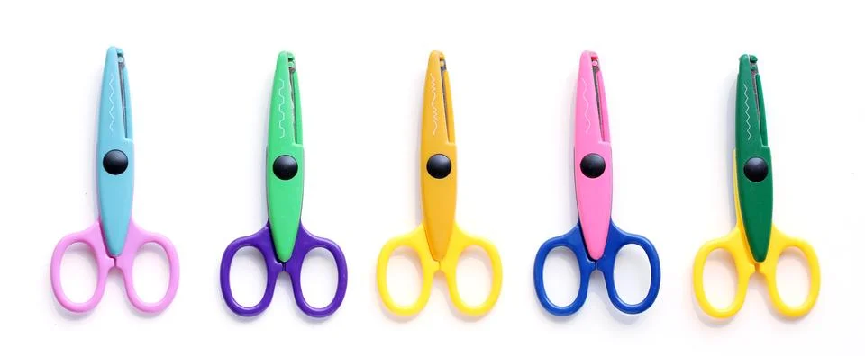 Five children's pinking shears in a row Stock Photos