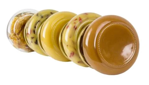 Five closed cans with different honey Stock Photos