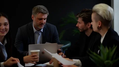 Five colleagues preparing documents before spending important negotiations in Stock Footage 257093072