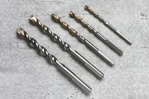 Five concrete drill bits on a concrete background Stock Photos