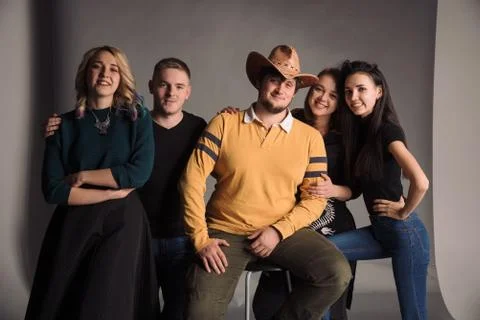 Five cool young friends standing together and smiling. The studio shot in the Stock Photos