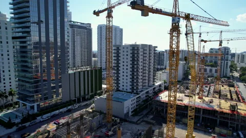 Five cranes building large tower in Miami Stock Footage 239884746