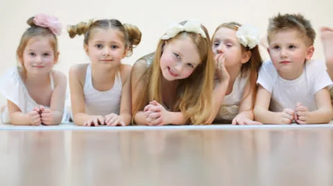 Five cute children sitting, talking and smiling isolated Stockbeeldmateriaal 22735171