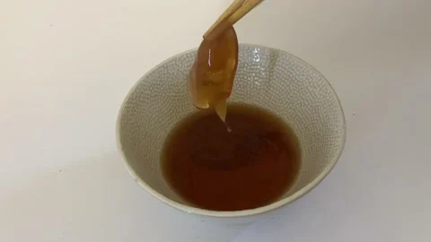 A five day old Kombucha SCOBY fermenting in a Jar Stock Footage 232855187