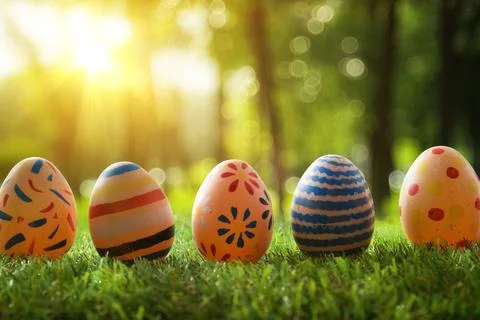 Five Decorated Easter Eggs in Sunny Forest Stock Photos