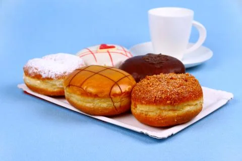 Five delicious, assorted donuts with coffee cup Stock Photos