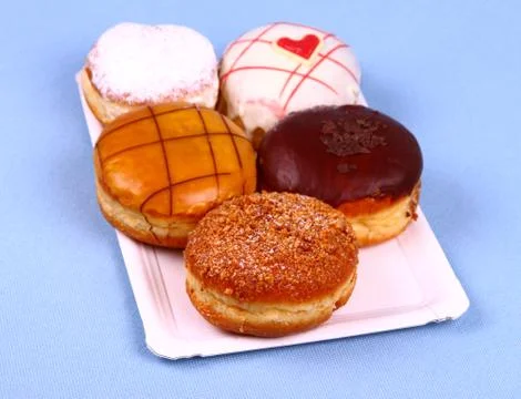 Five delicious, assorted donuts on plate Stock Photos