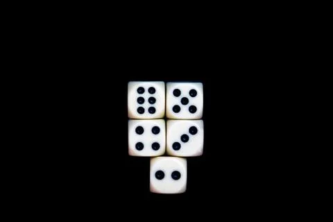 Five dices on a black background ready for starting the games Stock Photos