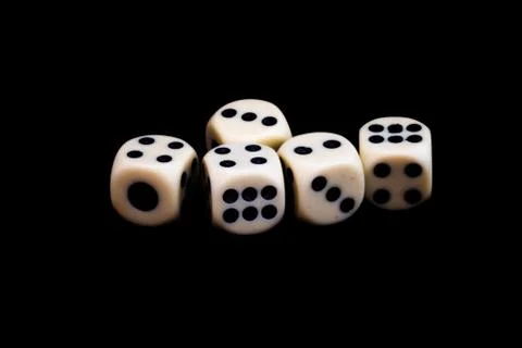 Five dices on a black background ready for starting the games Stock Photos