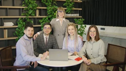 Five Different Business Professionals Led by an Older Businesswoman Sitting at a Stock-Footage 280283587