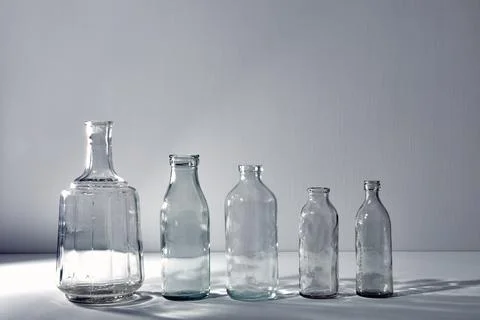 A five different empty glasses bottles with copy space. Graphic still life Stock Photos
