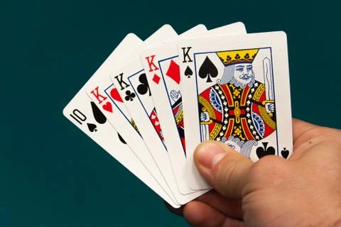 Five different play cards in a hand Stock Photos