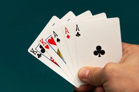 Five different play cards in a hand Stock Photos