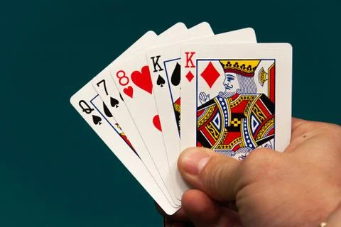 Five different play cards in a hand Stock Photos