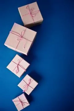 Five different sizes Christmas gift boxes on the blue background. Classic blu Stock Photos