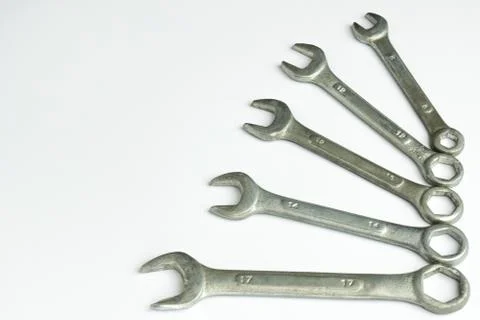 Five different wrenches lie on the right on a white background Stock Photos
