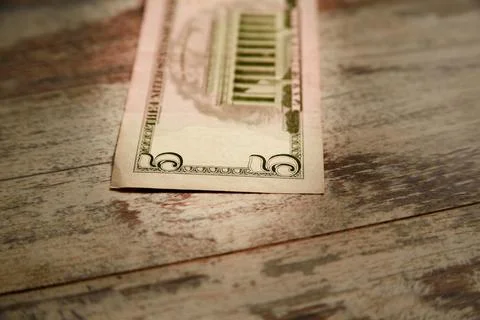 Five-dollar bill on a worn table close-up Stock Photos