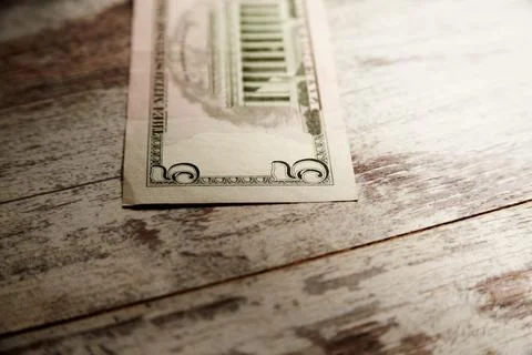 A five-dollar bill on a worn table Stock Photos