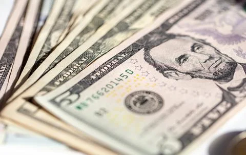 Five dollar bills close up, soft focus. Stock Photos