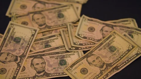 Five Dollar Bills in a Pile on a Table Stock Footage 94159409