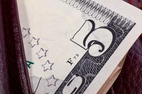 Five dollars is not a big part of the wallet. Macro. Close-up Stock Photos