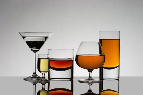 Five drinks back lit with reflections Stock Photos
