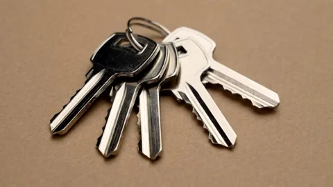 Five duplicate identical steel door keys in a bunch closeup Stock Footage 279472666