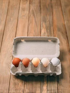 Five eggs on a wooden background Stock Photos