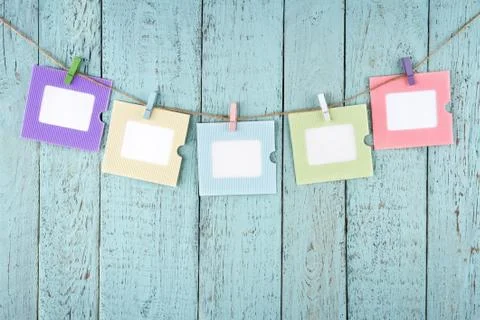 Five empty photo frames hanging with clothespins Stock-Fotos