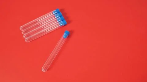 Five empty test tubes on red background. Stock Photos