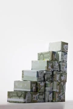 Five Euro banknotes folded into rectangular boxes and arranged into a staircase 스톡 사진